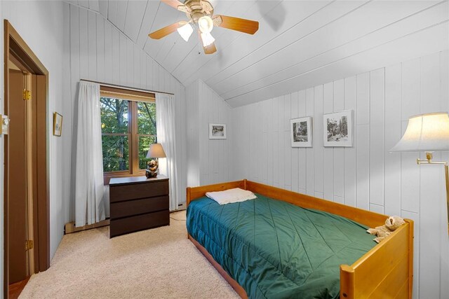 bedroom with carpet flooring, a ceiling fan, and vaulted ceiling