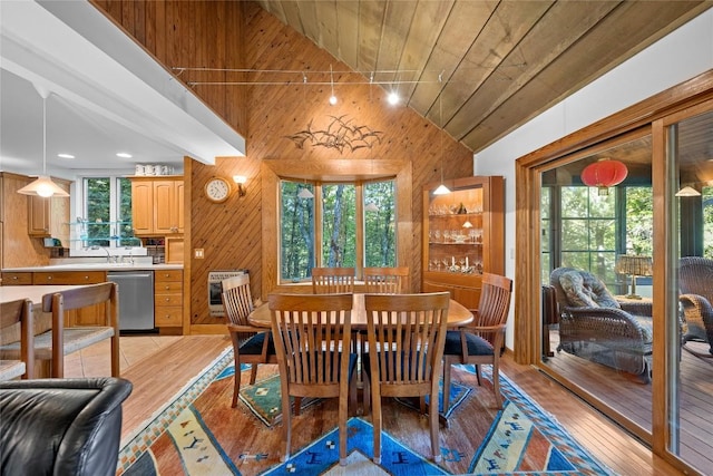 dining space featuring wood ceiling, wood walls, heating unit, and lofted ceiling