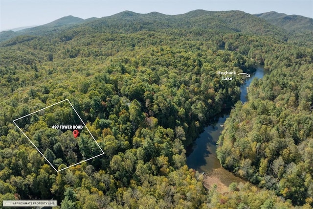 bird's eye view with a water and mountain view and a wooded view