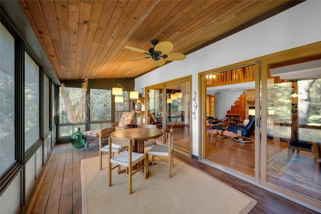 sunroom featuring wood ceiling, a ceiling fan, hardwood / wood-style flooring, and a wealth of natural light