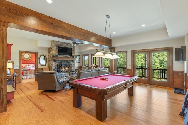 rec room featuring billiards, french doors, light wood-style floors, a fireplace, and ceiling fan
