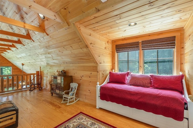 interior space with wooden walls, wood finished floors, and vaulted ceiling