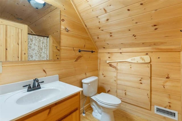 bathroom featuring wooden walls, vaulted ceiling, visible vents, vanity, and wooden ceiling