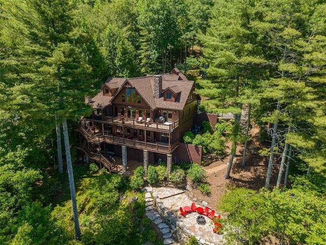 birds eye view of property with a view of trees