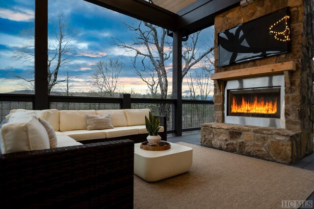 view of patio / terrace with an outdoor living space with a fireplace