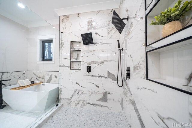 bathroom featuring tile walls and separate shower and tub