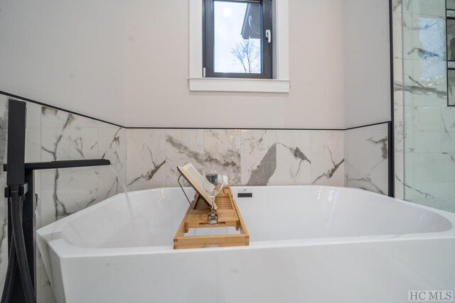 bathroom featuring a tub to relax in