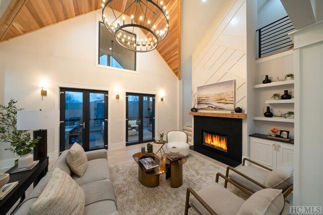 living room with built in shelves, high vaulted ceiling, french doors, and wooden ceiling