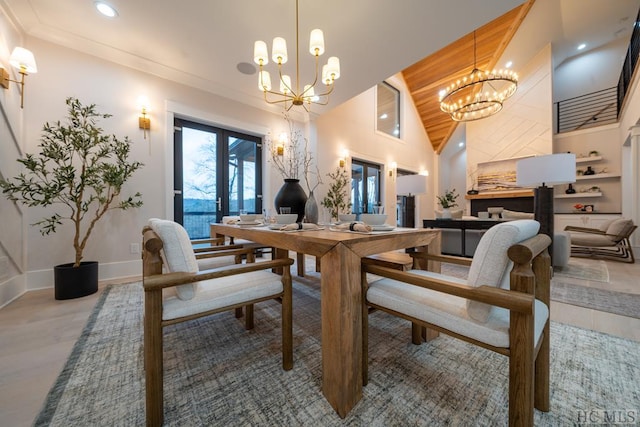 dining space featuring ornamental molding, french doors, high vaulted ceiling, and a notable chandelier