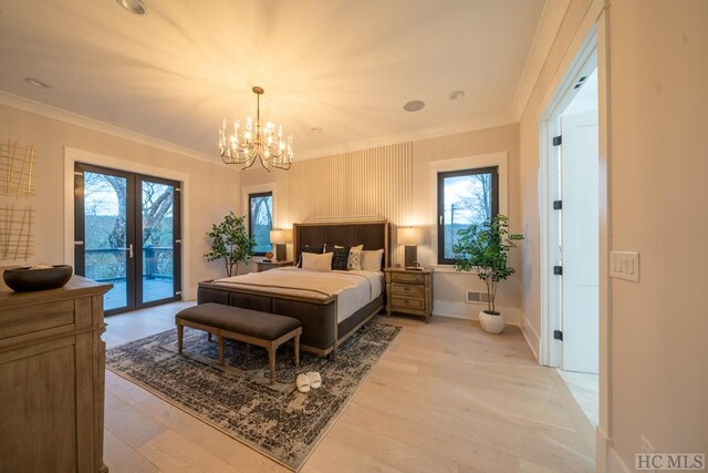 bedroom featuring multiple windows, access to outside, and light hardwood / wood-style flooring