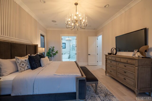 bedroom featuring crown molding, a notable chandelier, ensuite bath, and light hardwood / wood-style floors