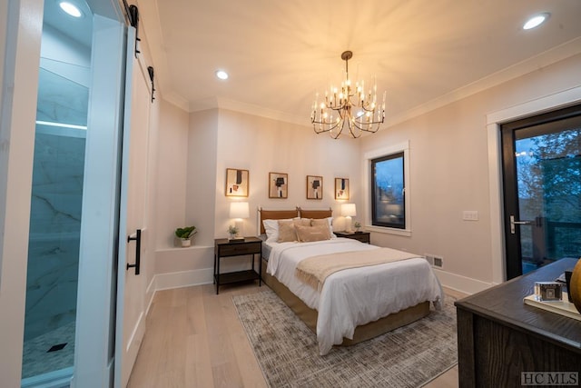 bedroom with ornamental molding, a barn door, and light hardwood / wood-style flooring