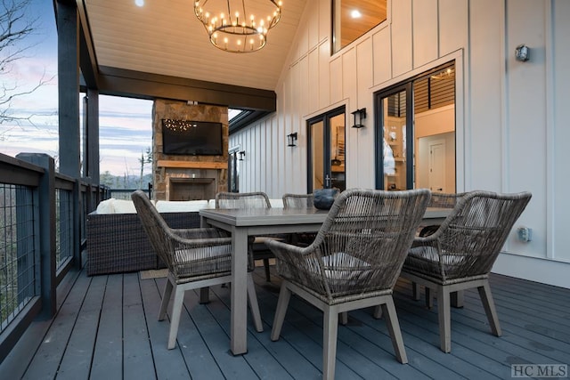 wooden deck featuring an outdoor stone fireplace