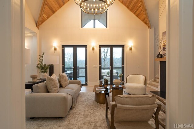 living room with high vaulted ceiling, wooden ceiling, an inviting chandelier, and french doors