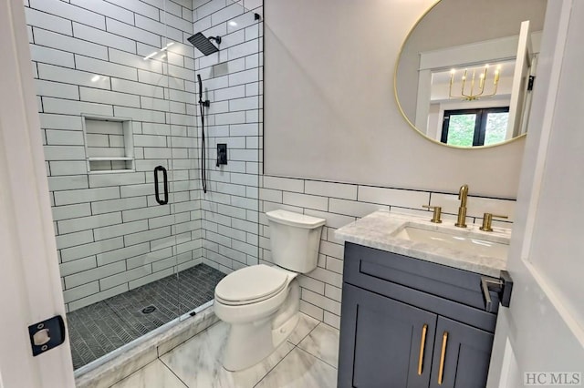 bathroom featuring tile walls, toilet, vanity, and walk in shower