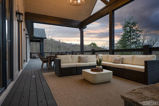 deck at dusk featuring an outdoor hangout area