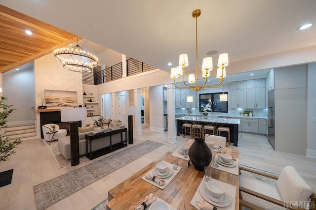 dining room with an inviting chandelier and a towering ceiling