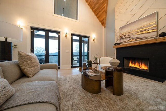 interior space featuring wood ceiling, high vaulted ceiling, and french doors