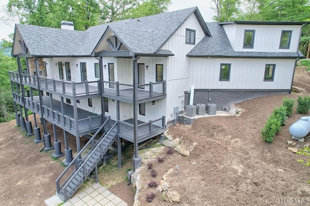 rear view of house with cooling unit and a wooden deck