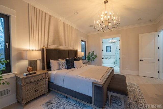 bedroom with light hardwood / wood-style flooring, crown molding, an inviting chandelier, and ensuite bathroom