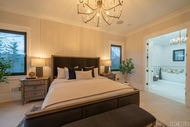 bedroom featuring a notable chandelier, light hardwood / wood-style floors, crown molding, and connected bathroom