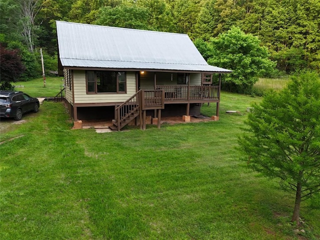 389 Kirkland Rd, Franklin, NC 28734 - back of property with stairs, a yard, metal roof, a forest view, and a deck