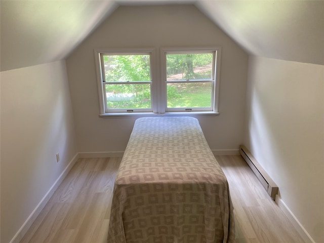 389 Kirkland Rd, Franklin, NC 28734 - bedroom with baseboard heating, light wood-type flooring, vaulted ceiling, and baseboards