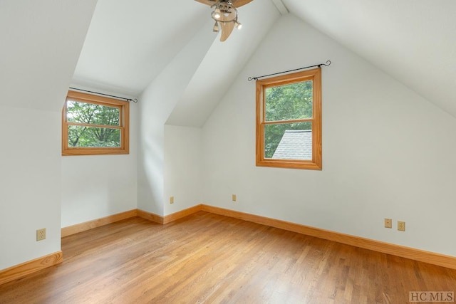 bonus room with ceiling fan, plenty of natural light, vaulted ceiling, and light wood-type flooring