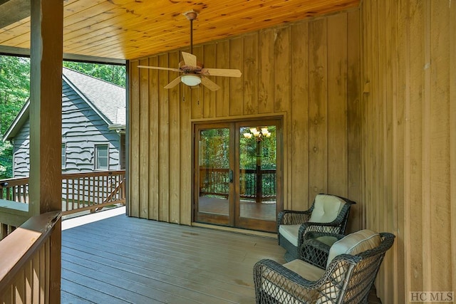 sunroom / solarium featuring lofted ceiling, wood ceiling, and ceiling fan