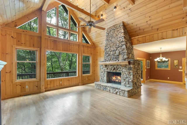 unfurnished living room with plenty of natural light, a stone fireplace, and light hardwood / wood-style flooring