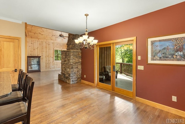 dining area with hardwood / wood-style floors and a chandelier