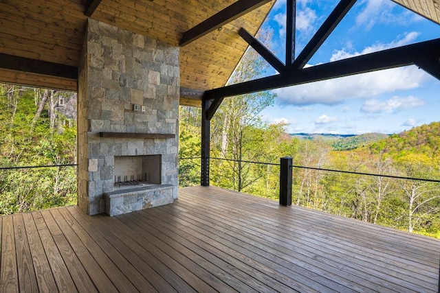 369 Firesong Ln, Glenville, NC 28736 - wooden deck featuring an outdoor stone fireplace and a view of trees