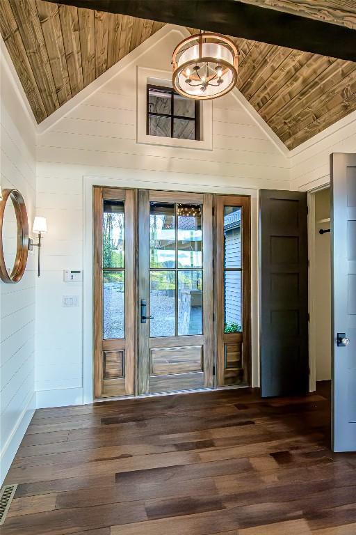 369 Firesong Ln, Glenville, NC 28736 - doorway featuring wooden ceiling, lofted ceiling, a chandelier, wood finished floors, and wood walls