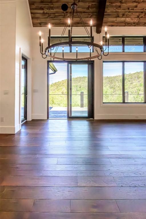 369 Firesong Ln, Glenville, NC 28736 - unfurnished dining area featuring a chandelier, dark wood-style flooring, baseboards, wooden ceiling, and beamed ceiling