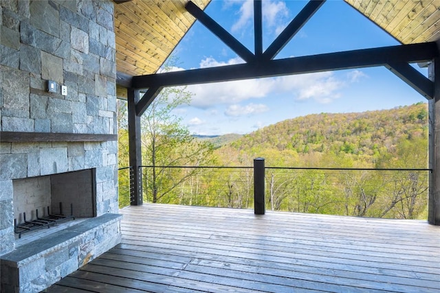 369 Firesong Ln, Glenville, NC 28736 - wooden deck with an outdoor stone fireplace and a wooded view