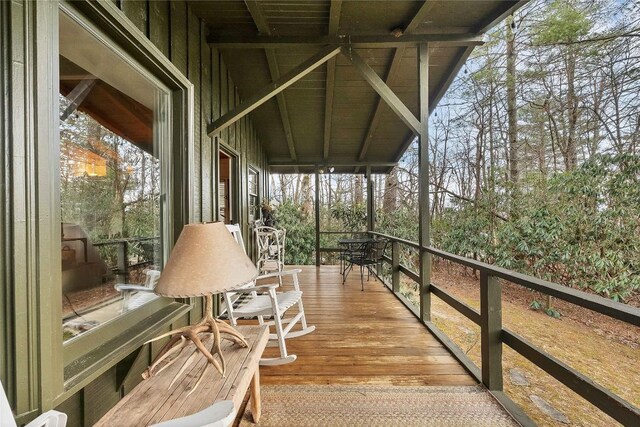 living room featuring wood-type flooring, wood ceiling, beam ceiling, and a fireplace