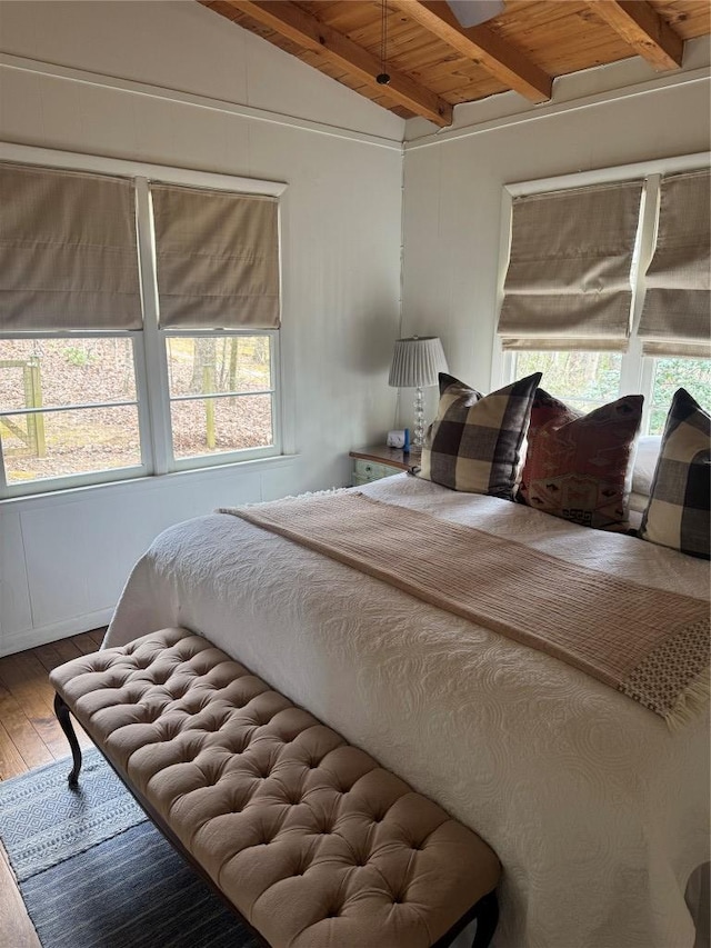 bedroom featuring hardwood / wood-style flooring, lofted ceiling with beams, and wooden ceiling