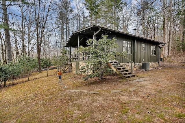 exterior space featuring central AC unit and board and batten siding