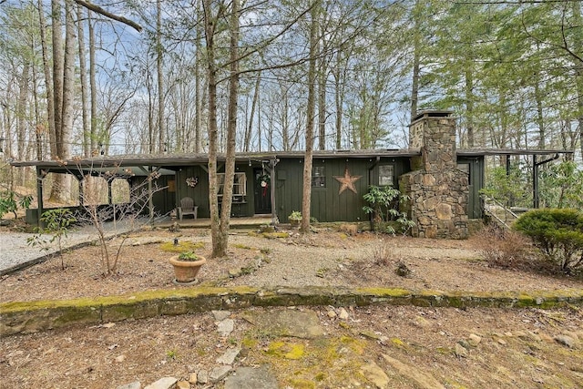 view of front of house with a chimney and board and batten siding