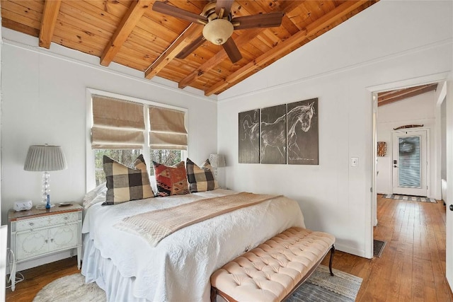 bedroom with visible vents, lofted ceiling with beams, ceiling fan, wooden ceiling, and hardwood / wood-style floors