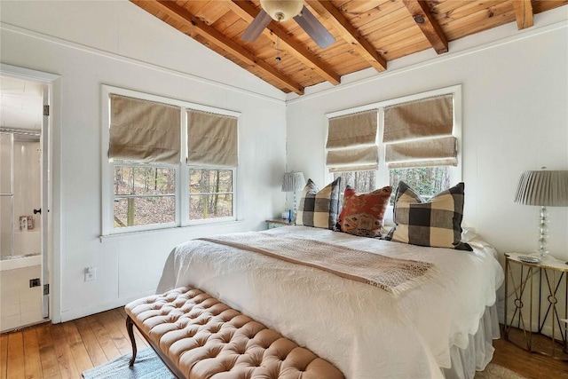 bedroom with vaulted ceiling with beams, wooden ceiling, multiple windows, and hardwood / wood-style flooring