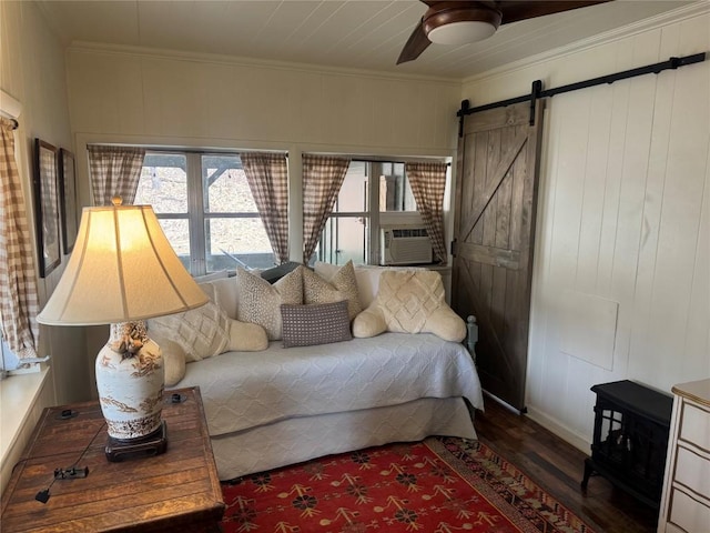 interior space featuring ceiling fan, cooling unit, ornamental molding, dark hardwood / wood-style flooring, and a barn door