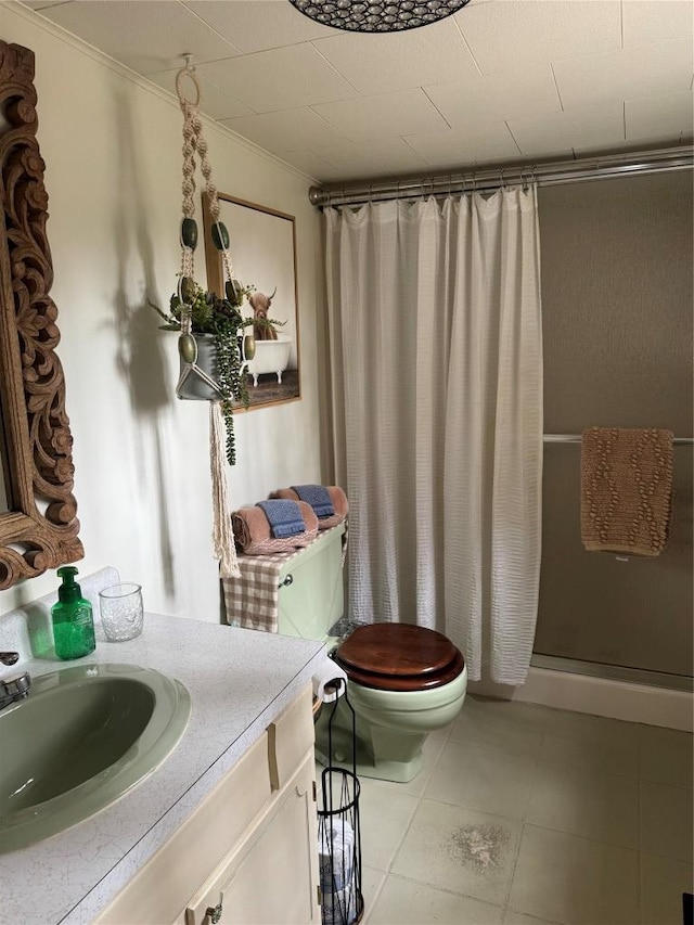 bathroom with walk in shower, vanity, toilet, and tile patterned flooring