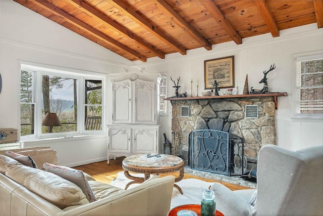 living room with lofted ceiling with beams, wooden ceiling, visible vents, and a wealth of natural light