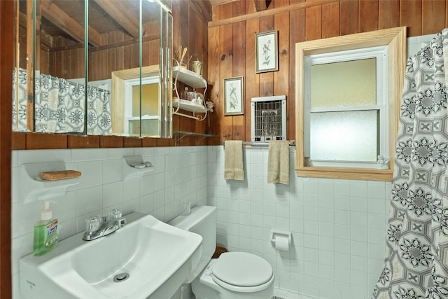 bathroom featuring sink, heating unit, and toilet