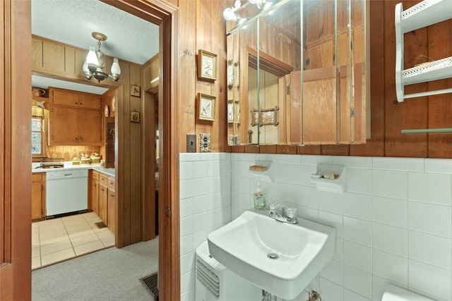 bathroom with tile patterned flooring, sink, and a textured ceiling