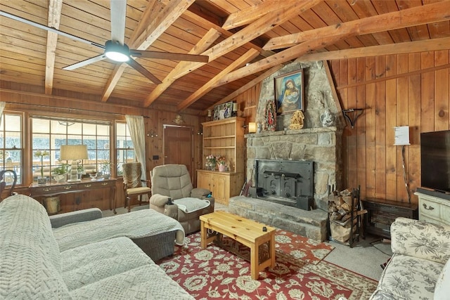 living room featuring a stone fireplace, wooden walls, vaulted ceiling with beams, ceiling fan, and wood ceiling