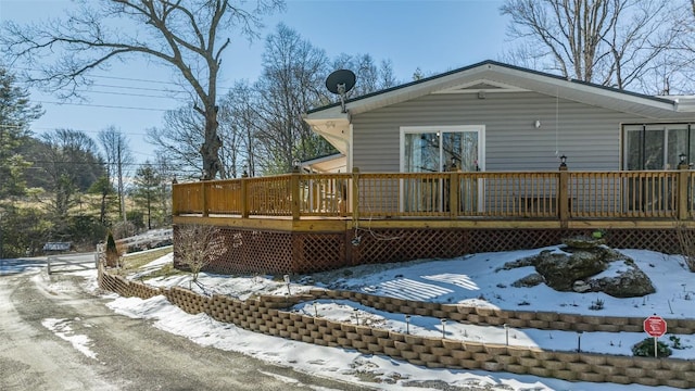 snow covered property featuring a deck