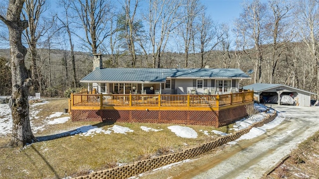 ranch-style home featuring a wooden deck and a carport