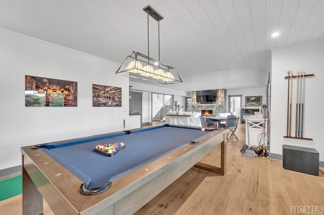 rec room featuring billiards, a fireplace, and light hardwood / wood-style floors